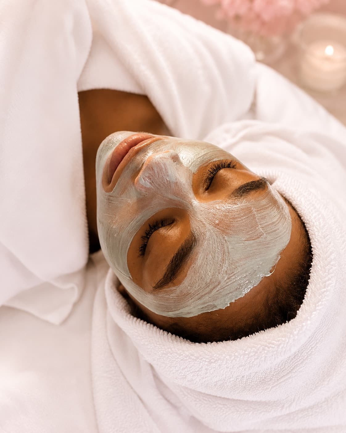 A hydrating mask midway through a facial, wrapped and candlelit