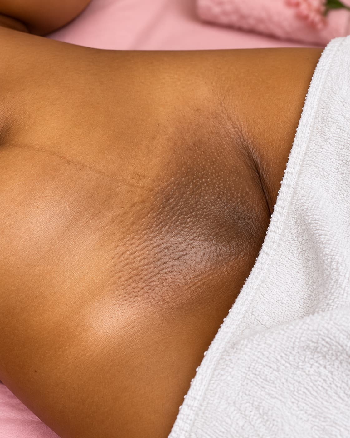 An underarm left smooth after waxing, wrapped on the treatment bed
